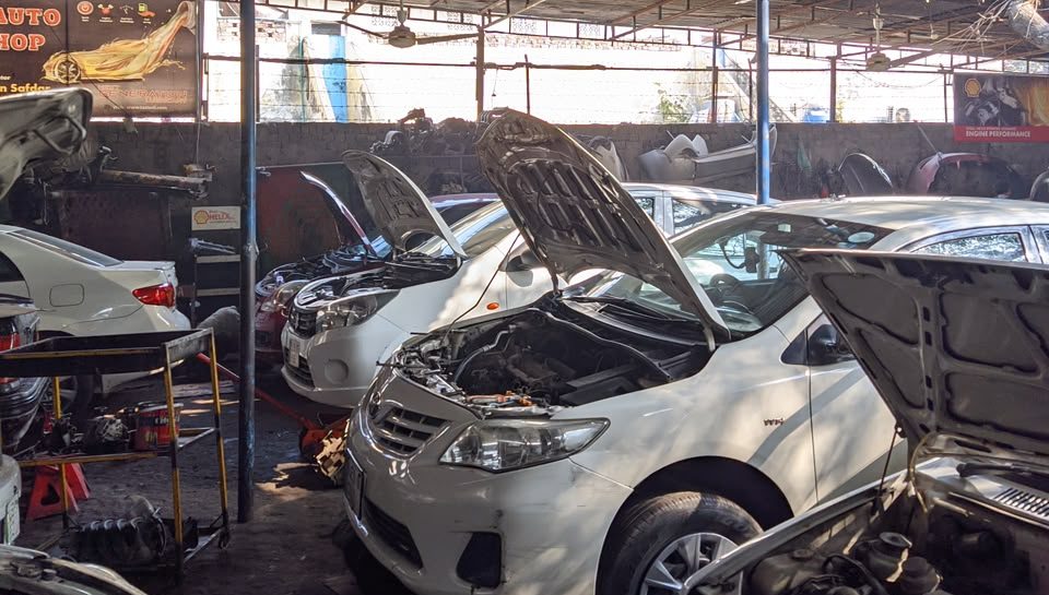 Toyota Corolla with an open bonnet in the Safdar Auto Workshop service bay