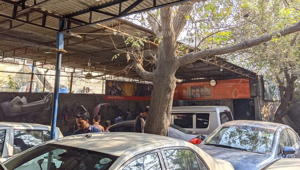Safdar Auto Workshop covered bays and yard with customer cars and mechanics